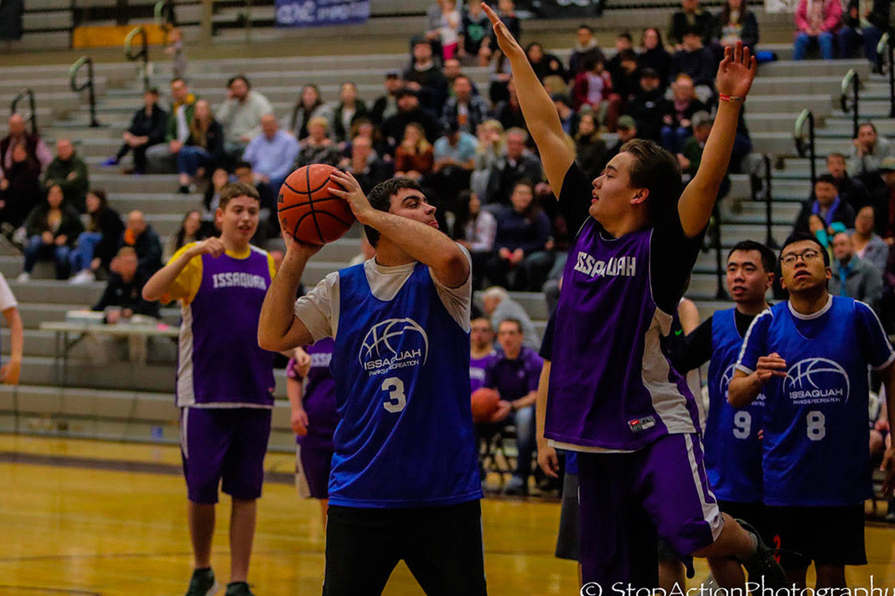 Issaquah player Mason Sanford, right, plays formidable defense during the eighth annual Special Olympics basketball game on Jan. 17 at Issaquah High School. Photo courtesy of Don Borin/Stop Action Photography