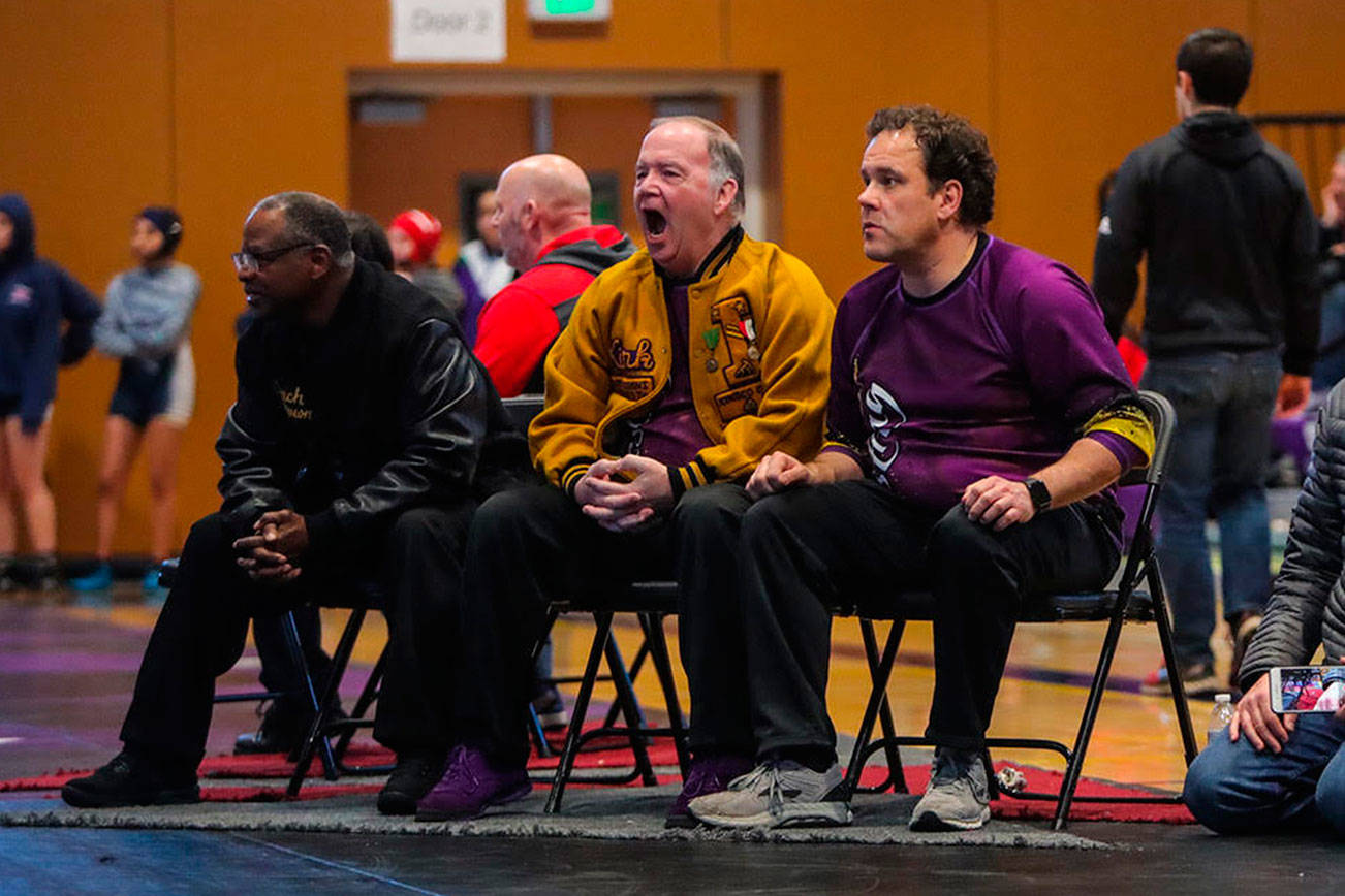 Issaquah Eagles wrestling head coach Kirk Hyatt (pictured in the yellow jacket) is in his 19th season as head coach of the wrestling program. Hyatt, who graduated from Issaquah High School in 1975, has lived in the same house just two miles outside of town for the past 36 years. Photo courtesy of Don Borin/Stop Action Photography