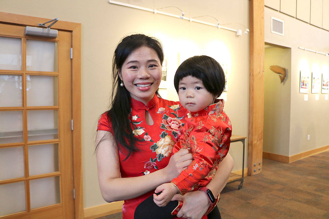 Lily Zou and 20-month-old Annie Yan wore traditional Chinese clothing for the celebration on Feb. 17. Stephanie Quiroz/staff photo.