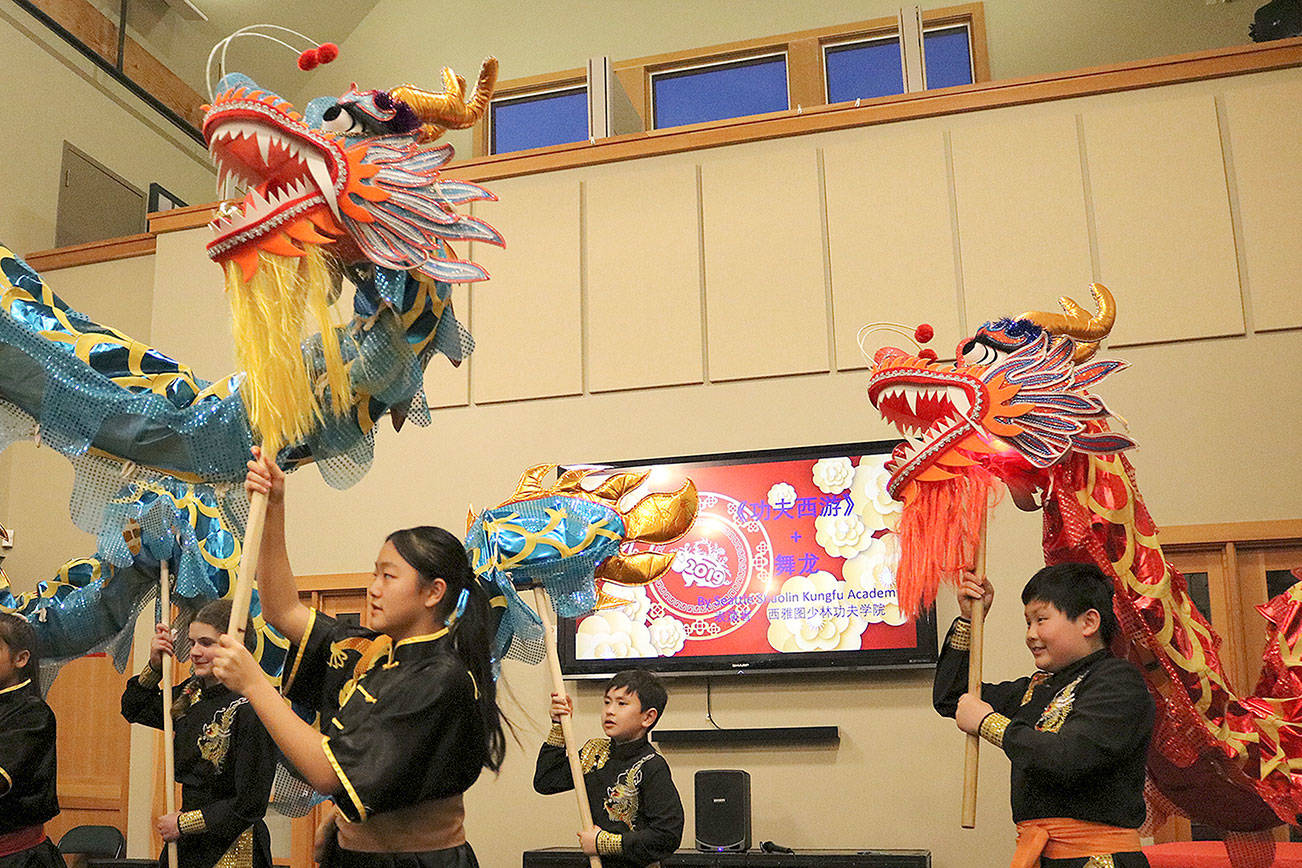 Seattle Shaolin Kungfu Academy (above) preforms a Dragon Dance and Kungfu and the Issaquah Highlands Red Dance group (below) preform at the Chinese New Year celebration on Feb. 17. Stephanie Quiroz/staff photos
