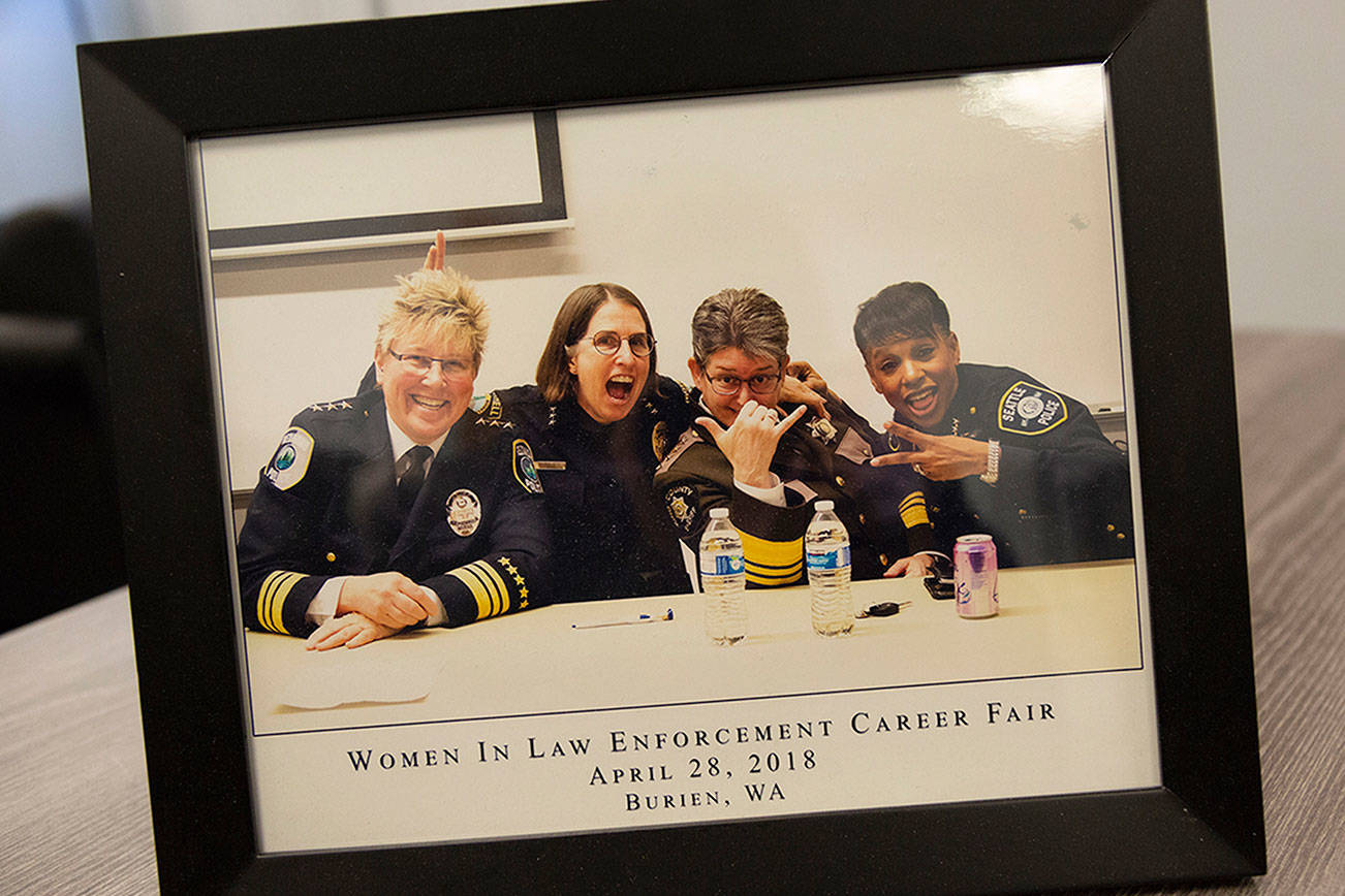 Redmond Police Chief Kristi Wilson, Bothell Police Chief Carol Cummings, King County Sheriff Mitzi Johanknecht and Seattle Police Chief Carmen Best smile in a photo on Johanknecht’s desk. They are some of Seattle’s leading women in law enforcement. Ashley Hiruko/staff photo