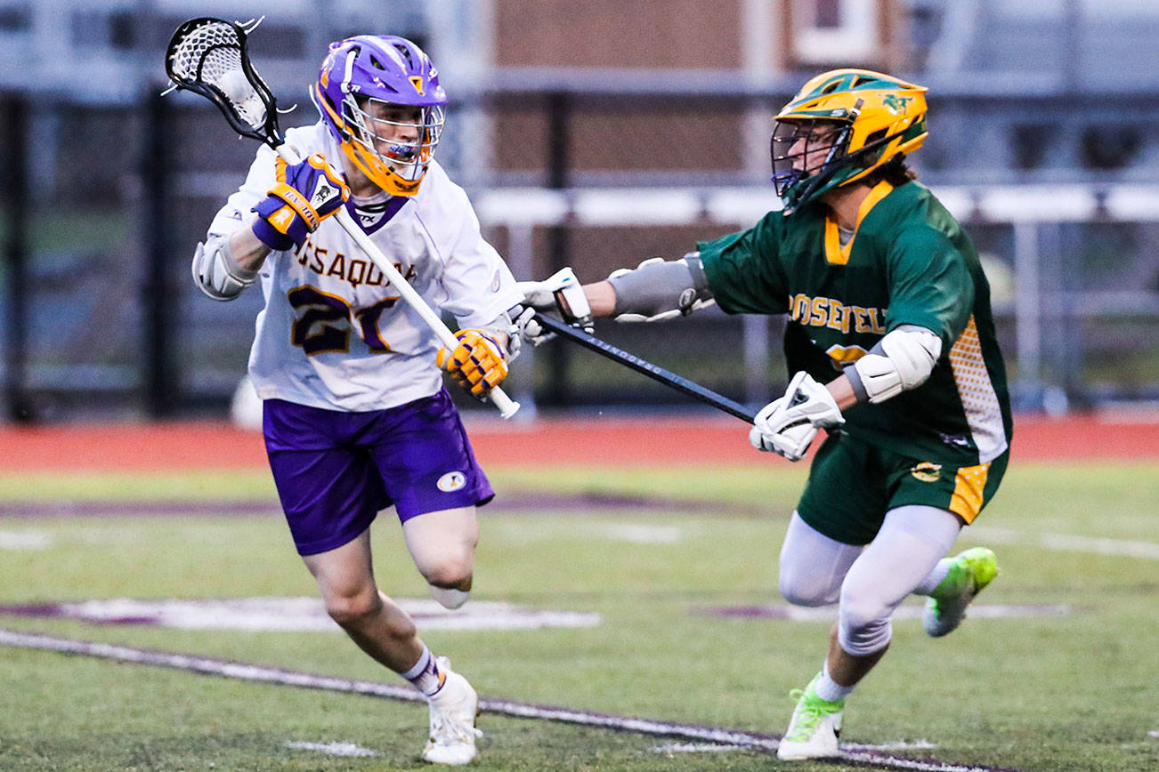 Issaquah senior Spencer Berntsen, left, scored two goals in his team’s 11-3 win against Roosevelt on March 22. Photo courtesy of Rick Edelman/Rick Edelman Photography