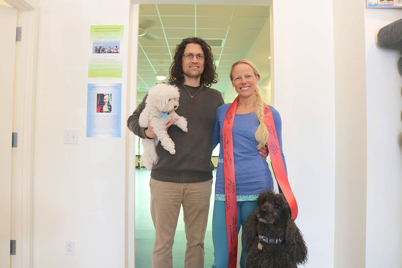 Dora Gyarmati, her husband Regan Pasko, and their dogs Albert (white dog) and Panni (black dog) in their new Issaquah studio. Stephanie Quiroz/staff photo