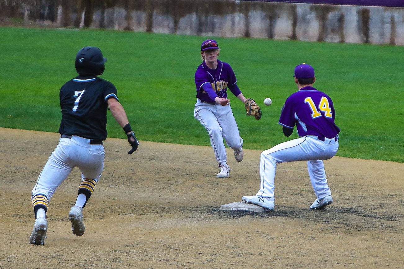 Issaquah Eagles shortstop Tyler Reese, left, and second baseman Joseph DePalo turn a game-saving double play in the top of the sixth inning with the bases loaded. Issaquah defeated Ingelmoor 2-0 on April 12 in Issaquah. Photo courtesy of Don Borin/Stop Action Photography
