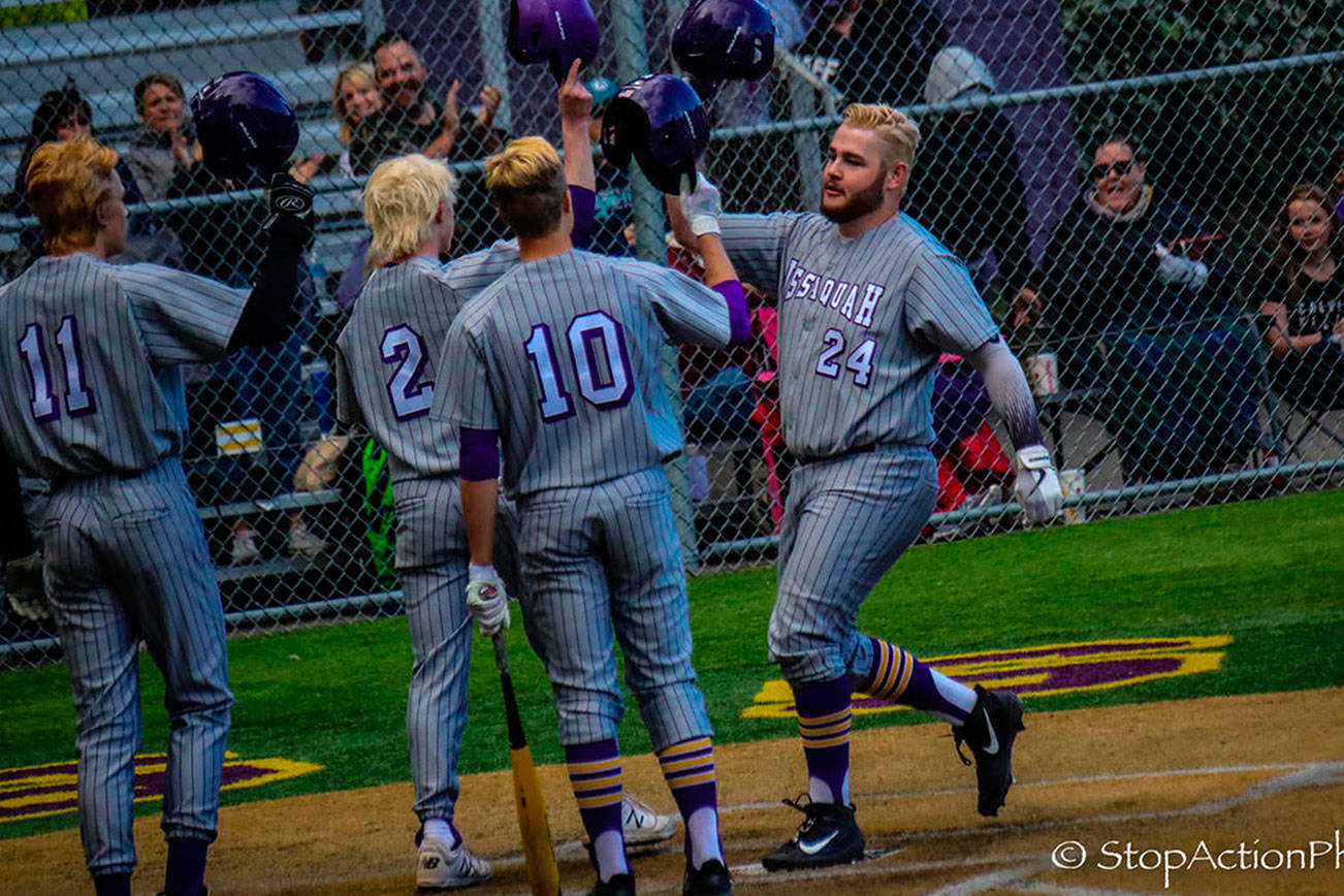 Issaquah Eagles slugger Cooper Thieme, right, crosses the plate in the bottom of the sixth after connecting on a three-run home-run to right field. Issaquah defeated Kamiak 6-0 in a loser-out playoff game on May 2 at Issaquah High School. Photo courtesy of Don Borin/Stop Action Photography