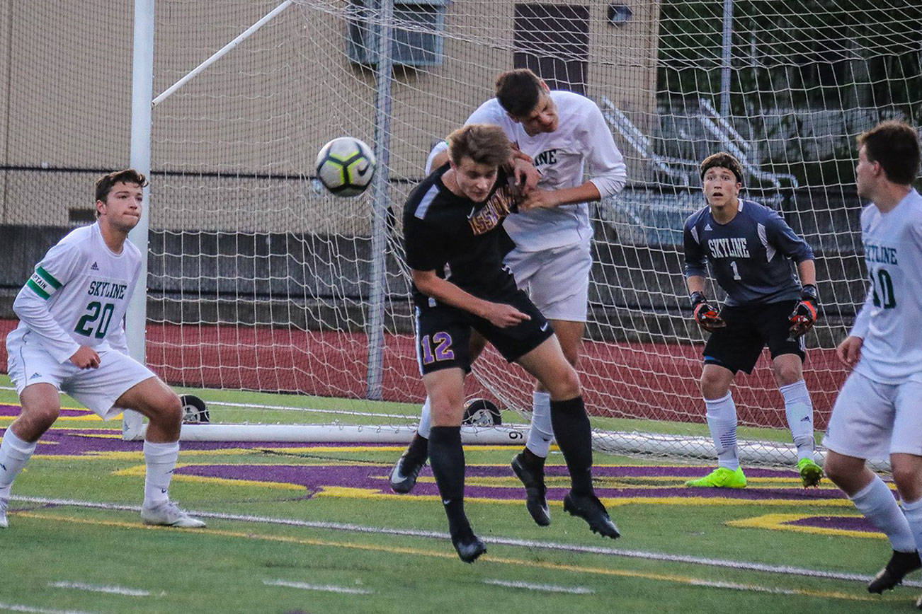 Issaquah senior forward Gavin Herman battles with a Skyline player in front of the goal. Issaquah defeated Skyline, 3-1, to keep its season alive on May 7. Photo courtesy of Don Borin/Stop Action Photography