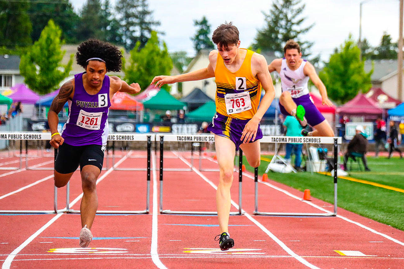 Issaquah Eagles sophomore Matt Wilkinson (center) captured eighth place in the 300 hurdles at the Class 4A state track meet in Tacoma. Photo courtesy of Don Borin/Stop Action Photography
