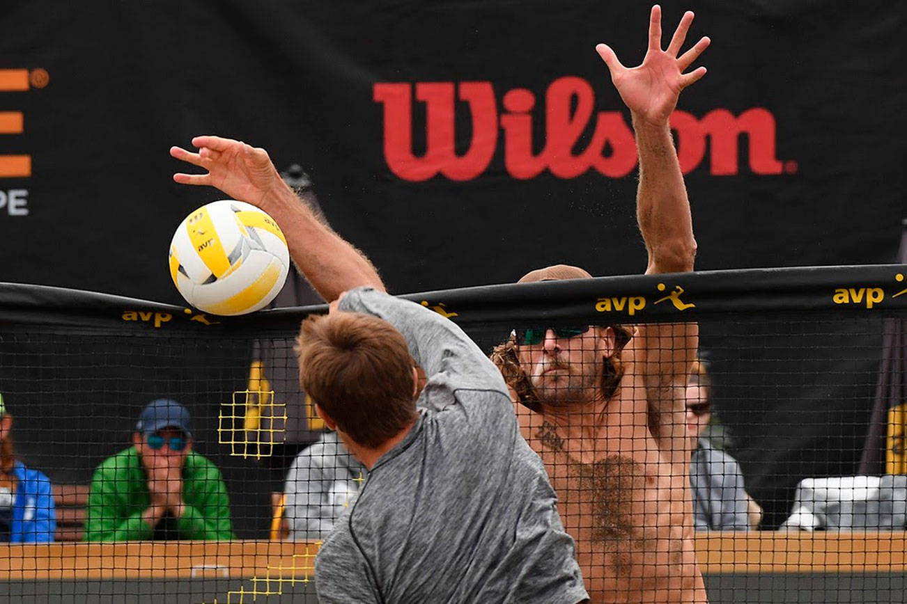 Jeremy Casebeer blocks a shot attempt by Taylor Crabb during the 2019 AVP Seattle Open men’s championship match on June 23 at Lake Sammamish State Park. Photo courtesy of Robert Beck