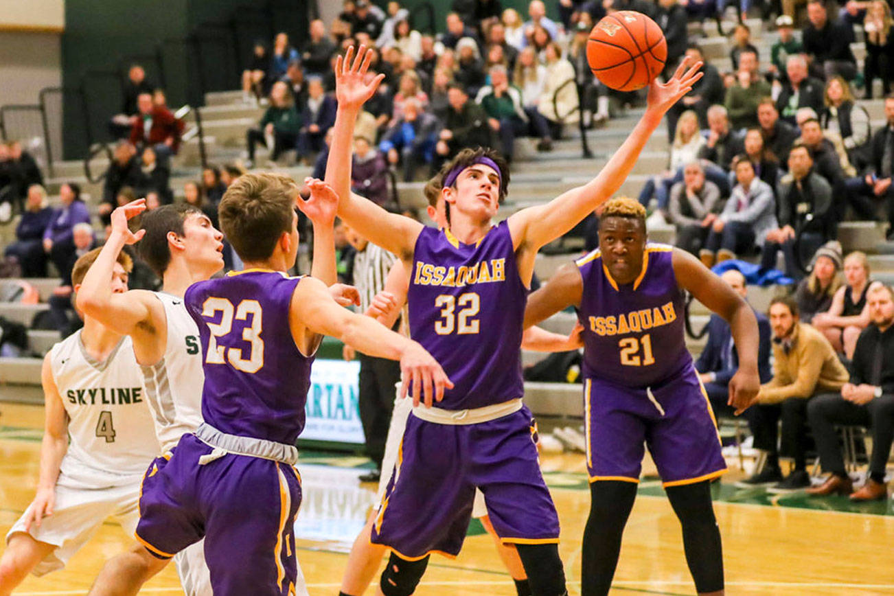Issaquah Eagles boys basketball player Charlie Dietiker (No. 32) corrals a rebound against the Skyline Spartans during the 2018-19 season. Photo courtesy of Rick Edelman/Rick Edelman Photography
