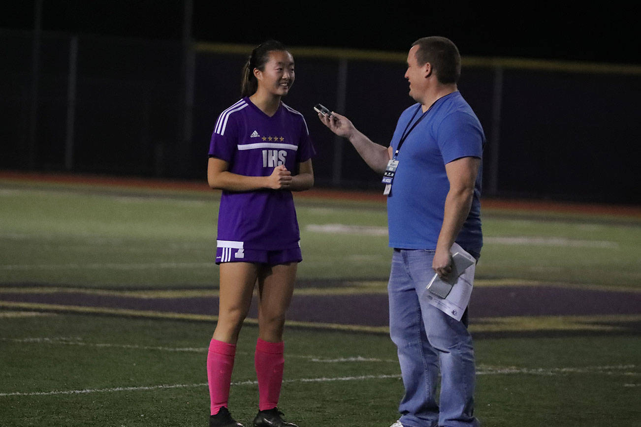 Sportswriter Shaun Scott interviews an Issaquah Eagles girls soccer player Sarah Kim during the 2018 season. Photo courtesy of Don Borin/Stop Action Photography