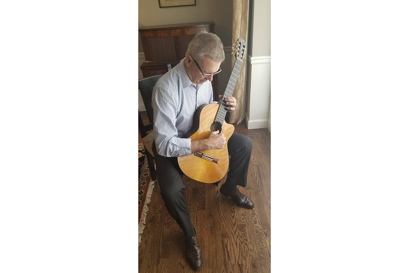 Mercer Island financial adviser Bob Toomey plays a classical guitar. Courtesy photo