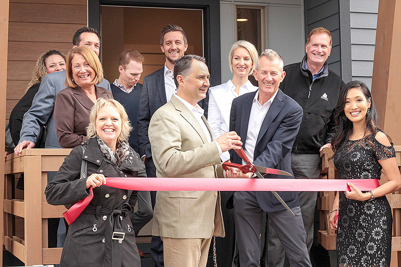 At left: Issaquah Chamber of Commerce held a ribbon cutting at RIVA townhomes on Sept. 24. Front row, from left: Conner Homes team Erin Fowler, Michael Lorenz, Charlie Conner and Libby Thacker; second row: Wendy Romine, Eric Espey, James Yorkston, Queen of Issaquah Katie Bosseler, and the SUHRCO property management team. Natalie DeFord/Staff photo