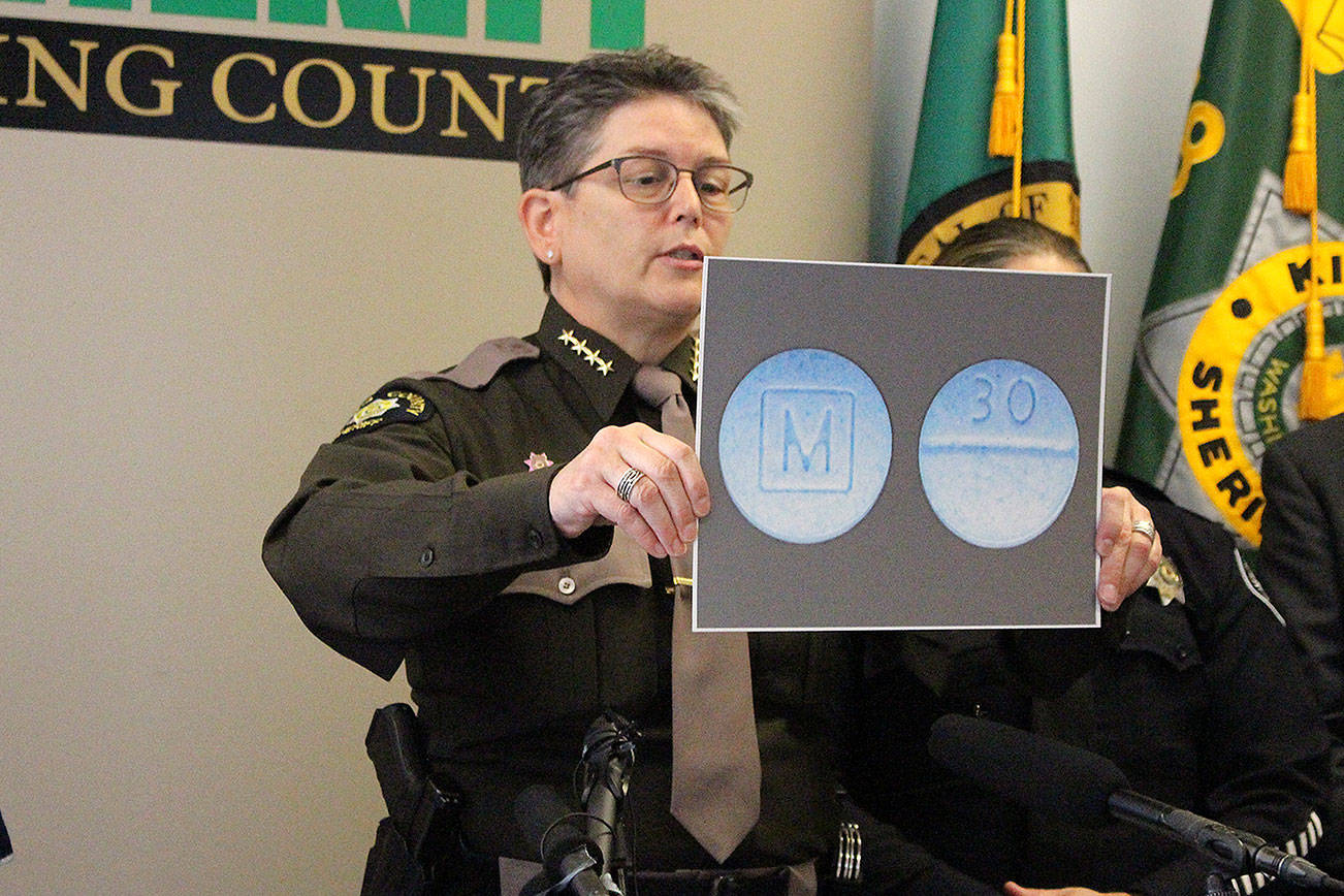 King County Sheriff Mitzi G. Johanknecht shows what M30 pills look like at a news conference Wednesday. Madison Miller / staff photo