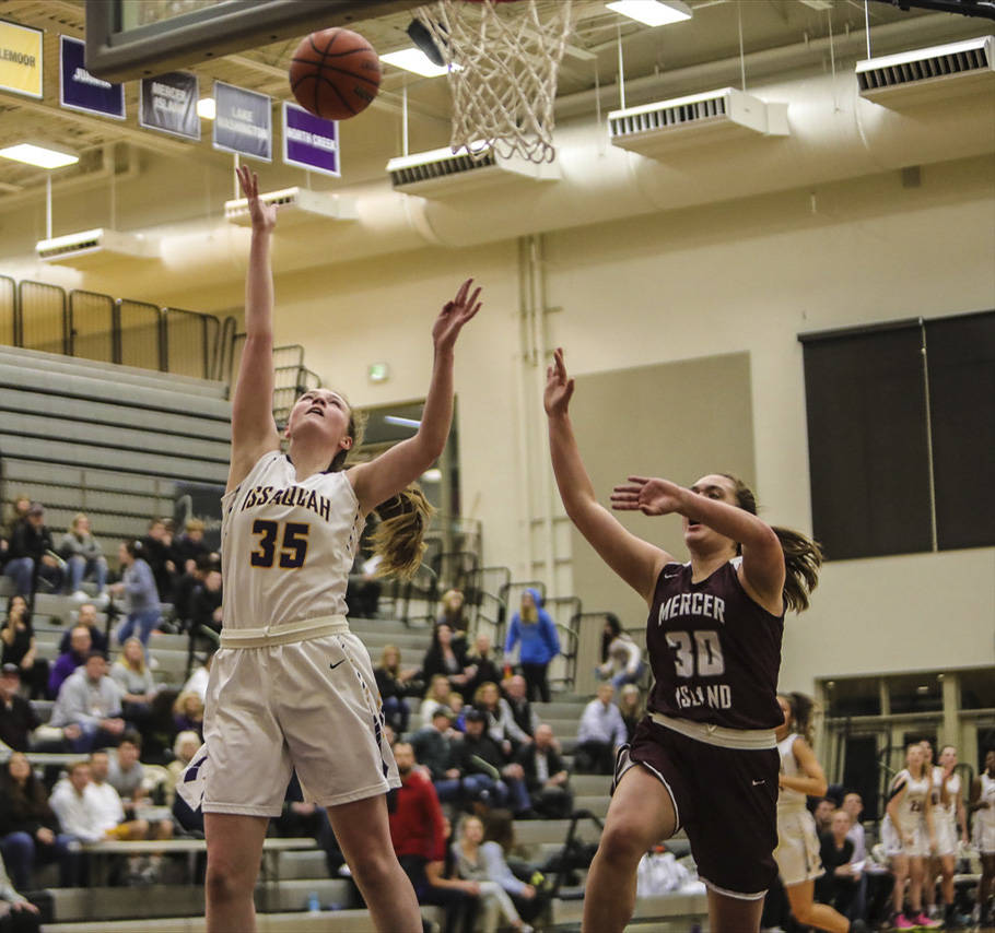Issaquah center Katie MacNary (left) scored a game-high 14 points during a 60-14 victory over Mercer Island on Dec. 4. Photo courtesy of Don Borin/Stop Action Photography