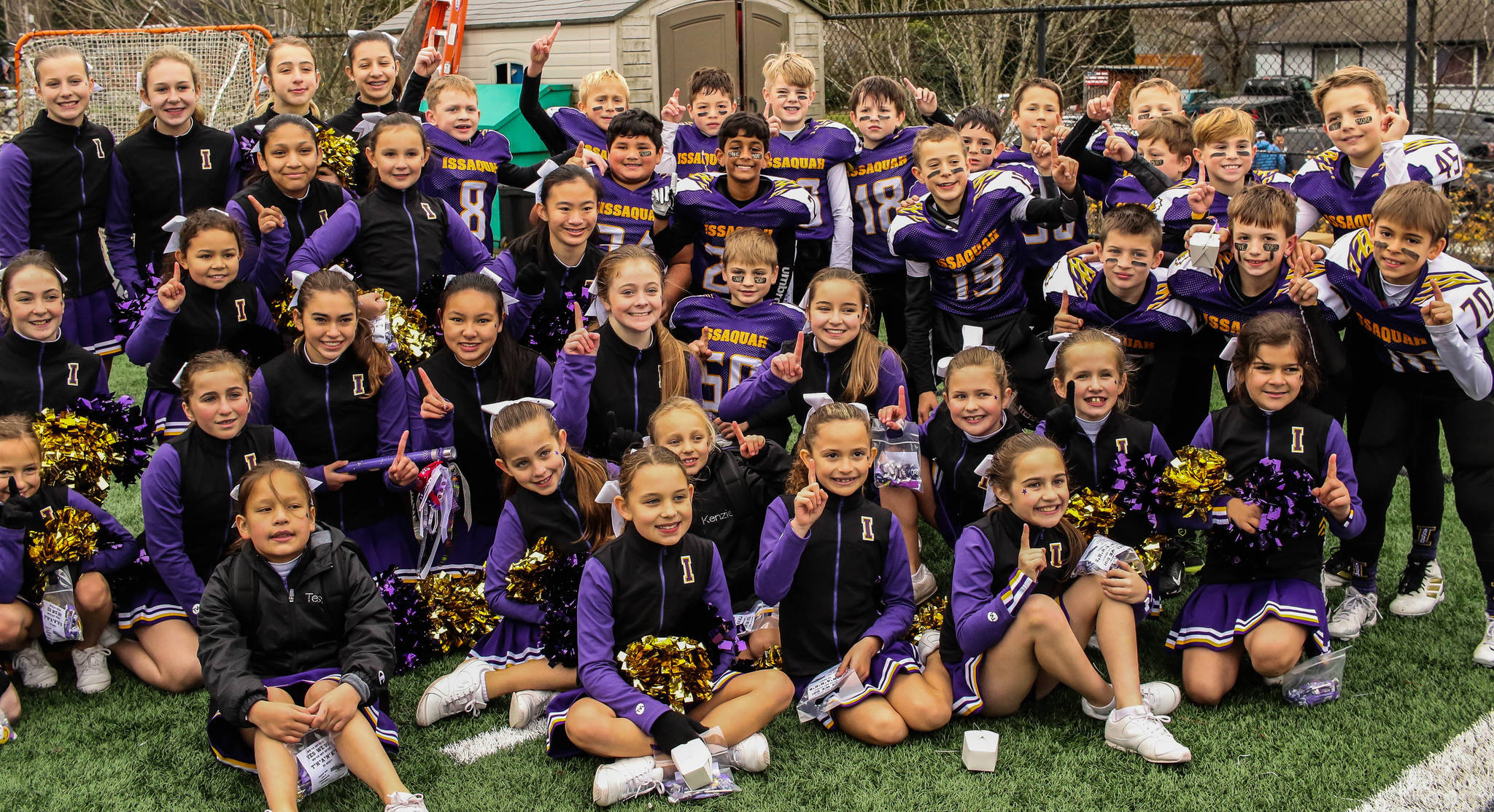 The Issaquah Rookie youth football team celebrates its Greater Eastside Junior Football Association championship along with the cheerleaders. Photo courtesy of Tricia Barry