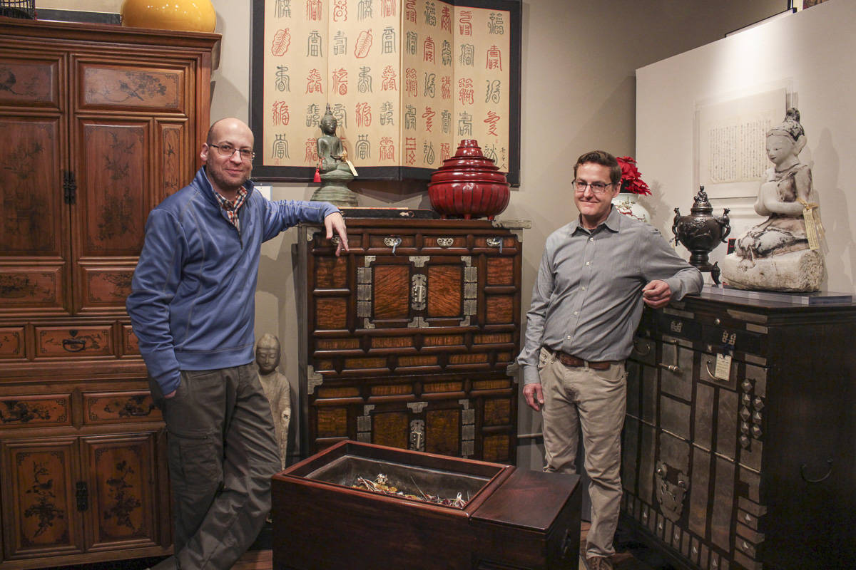 Natalie DeFord/staff photo                                Caanon Russell, left, and Matt Acres inside Ming’s Zen Gallery in downtown Issaquah. The space holds hundreds of pieces of art, furniture and antiquities.