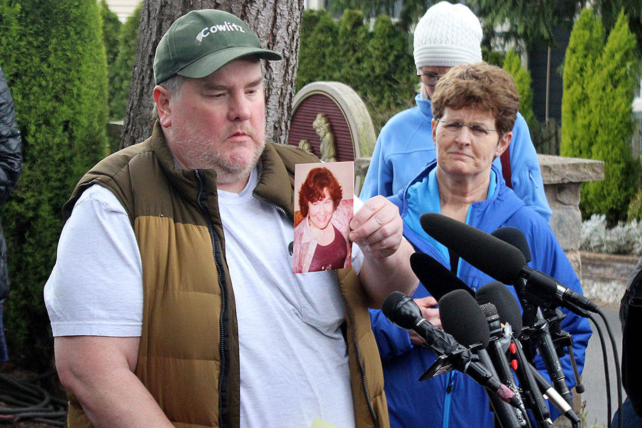 Mike Weatherill holds up a picture of his mother, Louise, at a March 5 press conference. Louise, who was a resident of Life Care, died yesterday. It is unknown whether she died from coronavirus. Blake Peterson/staff photo