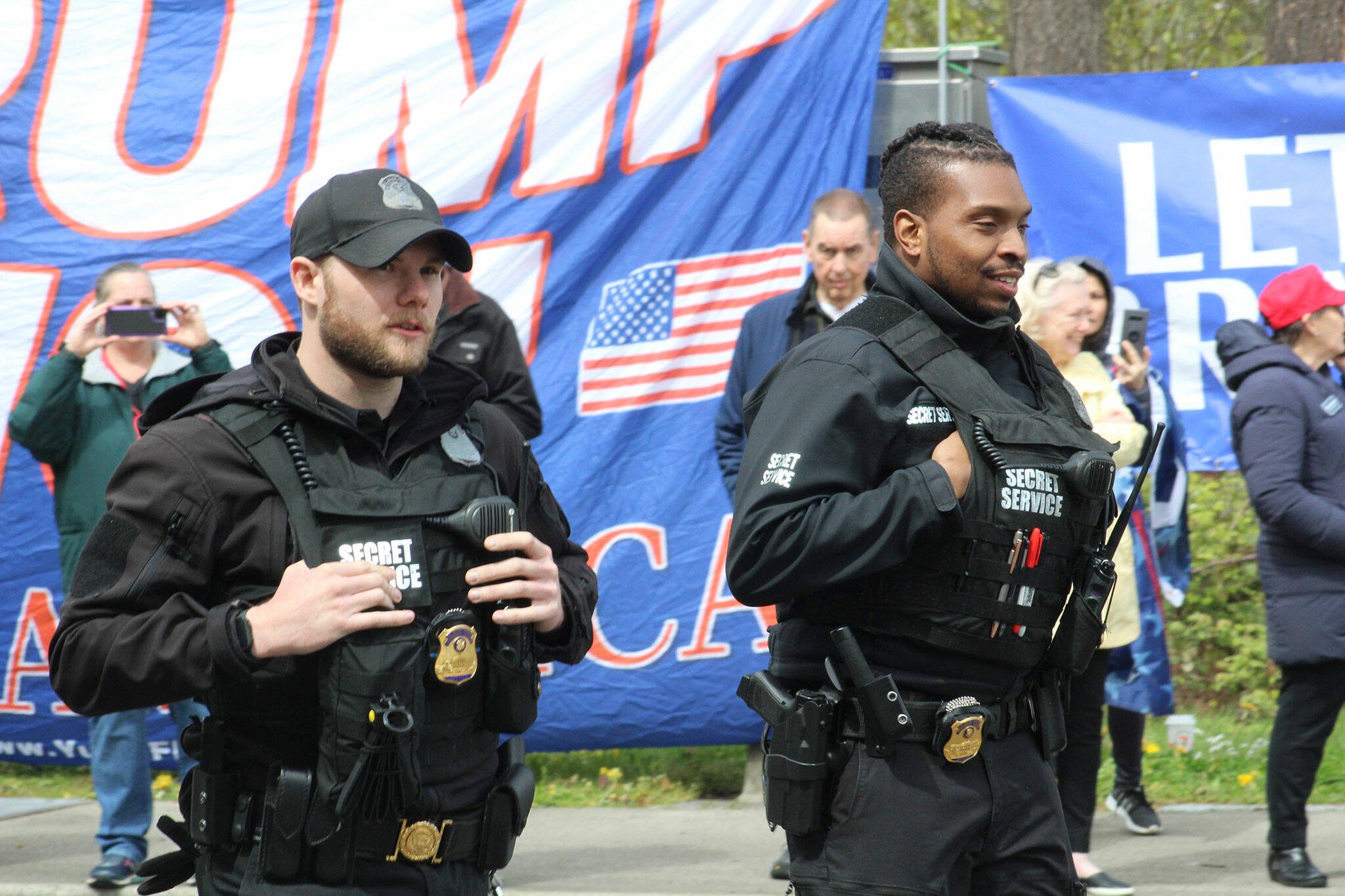 Two Secret Service agents patrol the crowd outside Green River College. Photo by Alex Bruell/Sound Publishing