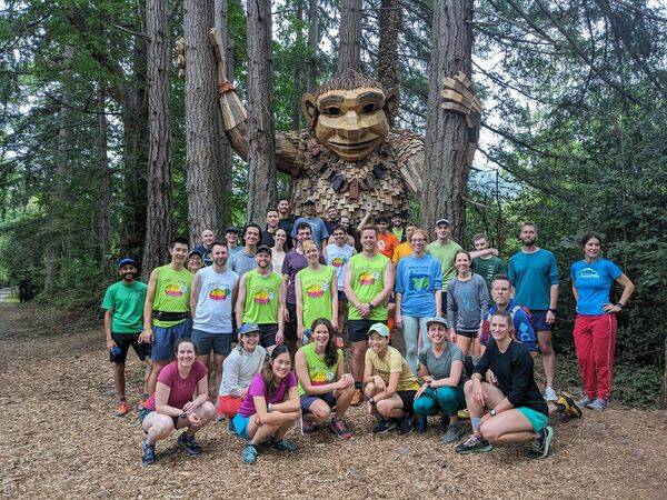 <p>Runners celebrate their 100th run with Jakob Two Trees. (Photo courtesy of Kelly Jiang)</p>