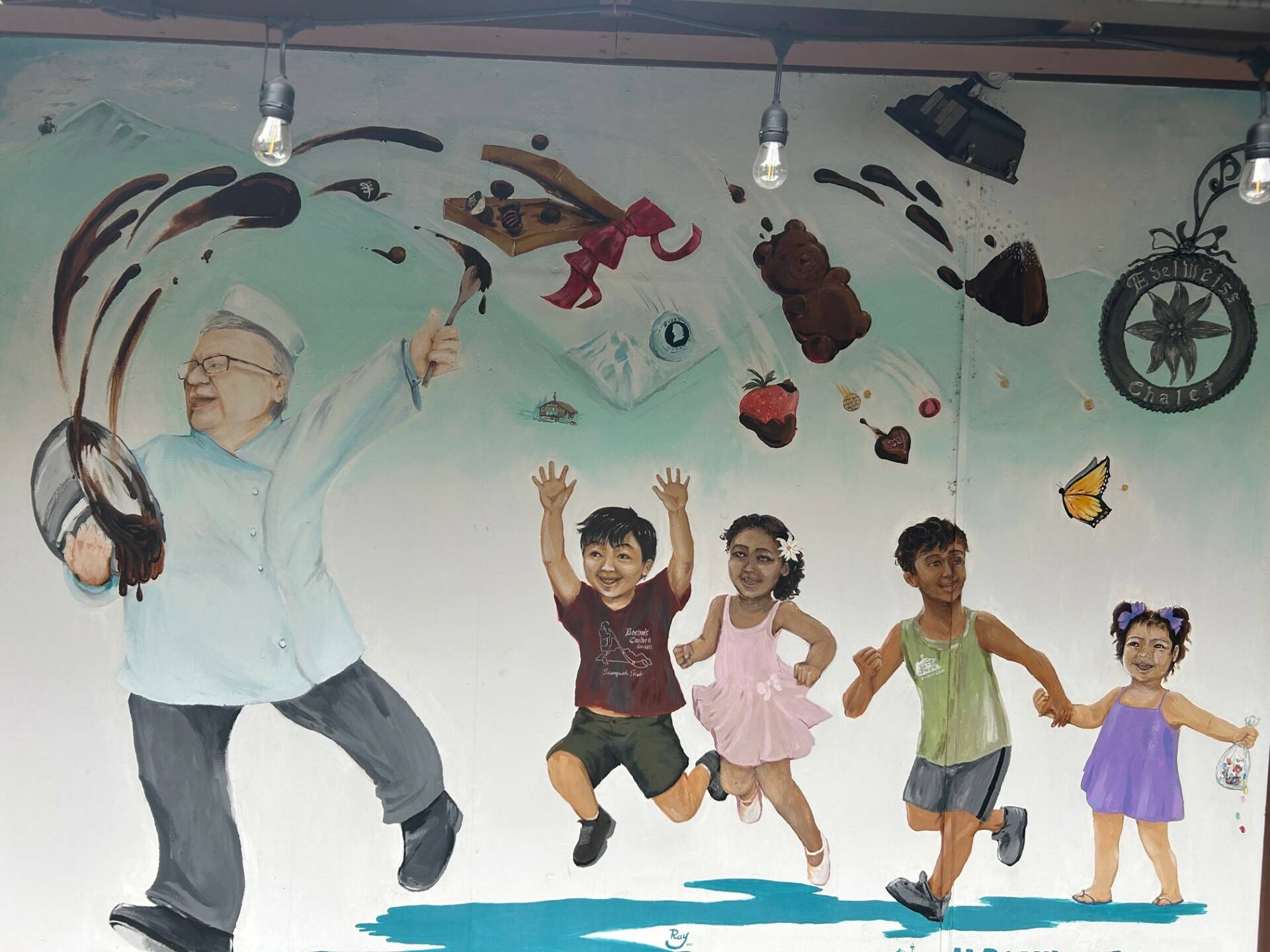 A mural of Bernard and his grandchildren is painted outside of the shop. (Photo by Cameron Sires/Sound Publishing)