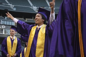 A student shows his enthusiasm as he enters Safeco Field for graduation.