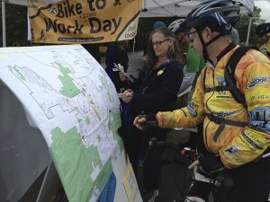 Mark Griffin (right) talks with Mary Joe de Beck while examining a map of Issaquah and the bike routes throughout the city.