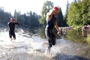 The leaders in the mens 'elite' group emerge from the water en route to the cycling transition area