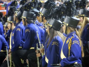 Issaquah band members look on as the Washington band takes the field.
