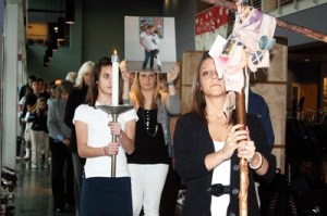 Eastside Catholic senior Danielle Ulrich leads a sombre procession through the school on Wednesday afternoon