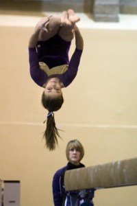 Issaquah High School gymnast Kelly Richards performs her dismount from the beam during Saturday’s KingCo 4A championship meet.