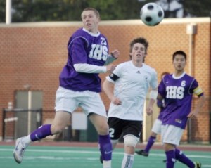 Issaquah's Quinn Grisham battles for a ball with Redmond's Chase Halen Tuesday night. Grisham had three goals in the Eagles' 3-0 victory.