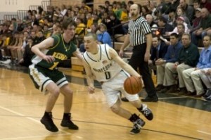 Skyline guard Nick Crossan drives on Redmond’s Chris Harrington Tuesday night. Crossan scored a game-high 24 points