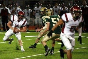 Eastlake quarterback Kelby McCorkle scrambles away from the Redmond defense Friday night.