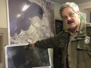 Ranger Rich Benson stands near maps of the park.