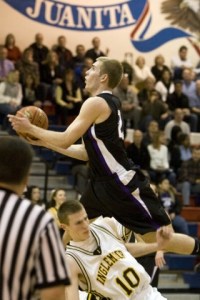 Issaquah's Robby Primrose takes flight over Inglemoor's Todd Campbell last Friday.