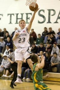 Skyline's Connor Gacek skies over a Roosevelt defender Tuesday night.
