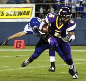 Issaquah wide receiver Adam Dondoyano tries to break free from Bothell's Nick Anthony Saturday night at Qwest Field.