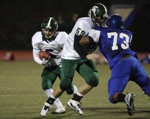 Skyline's Matt Trueblood puts a block on Curtis' Cornelius Edison leading the way for running back Nick Beauchamp in the first quarter of Saturday's 49-14 win.