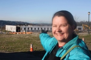 YWCA Seattle-King-Snohomish CEO Sue Sherbrooke points towards the future home of the YWCA affordable housing development in the Issaquah Highlands. The YWCA Family Village at Issaquah is scheduled to be built by September 2011.
