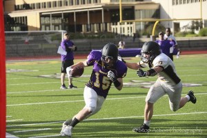 An Issaquah Eagles player makes a move upfield after hauling in a pass during the Issaquah Eagles football team's spring scrimmage on June 16 at Issaquah High School. The Eagles scrimmage came to an end earlier than expected due to inclement weather conditions.