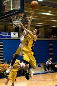 Ross Zuhl powers up a shot against South Kitsap’s Tionne Curry Monday afternoon.