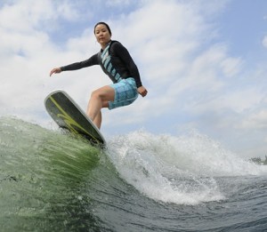 Grace Han Stanton enjoys the ride during a wake surfing session on Lake Sammamish recently.