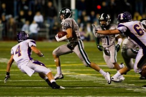 Skyline's Jordan Simone runs up field after intercepting Issaquah's Braden Bouwman Friday night. The Eagles' Spencer Warren goes in for the tackle.