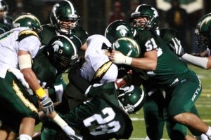 A group of Skyline tacklers led by Anthony DeMatteo (51) and Tommy Aarts (28) bring down Kentridge quarterback Caleb Smith.