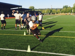 Eastside Bulldogs running back Isaac Syph Jr. carries the upfield during a practice session on Aug. 11 at Renton Memorial Stadium.