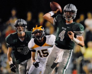 Skyline QB Max Browne (4) eludes Wolverine DB Matt Gilbert (15) during a game against Bellevue at Skyline High School in Sammamish on Friday. The visiting Wolverines beat the Spartans 31-17.