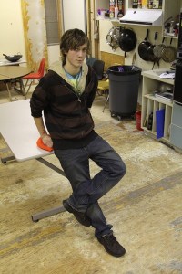 Garrett Lampson sits in Tiger Mountain Community High School’s kitchen Monday. The floors were torn up and walls stripped when black mold was discovered. Students are using the torn up space for their culinary class while they wait for the district to decide on redesign plans.