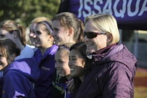 Issaquah head coach Gwen Robertson (far right) looks on during a state meet with her team.