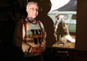 Ben Harrison flips through slides of the Bandera Mountain fire in 1958. He was one of many people who fought the fire for several months. On the screen