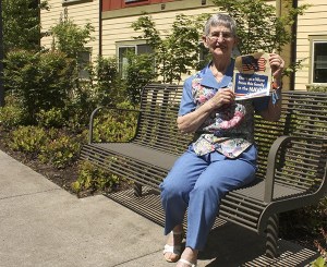 Margie Vines shows off the flyer her parents displayed in their cabin after she was sent off as a member of the first all female branch of the United States Navy in 1942.
